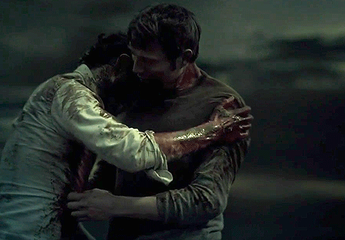 GIF of Hannibal and Will embracing on the cliff top.