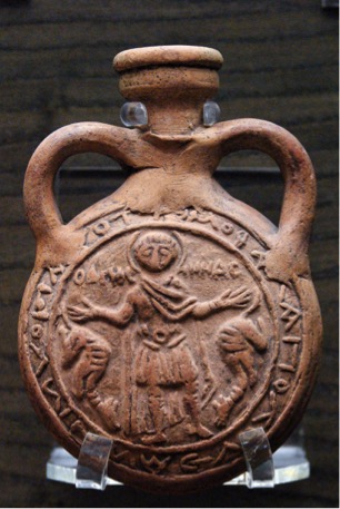 upright brown flask with two handles, figurine in center