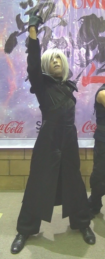 Cosplayer wearing a steampunk military coat, raising a hand to the sky