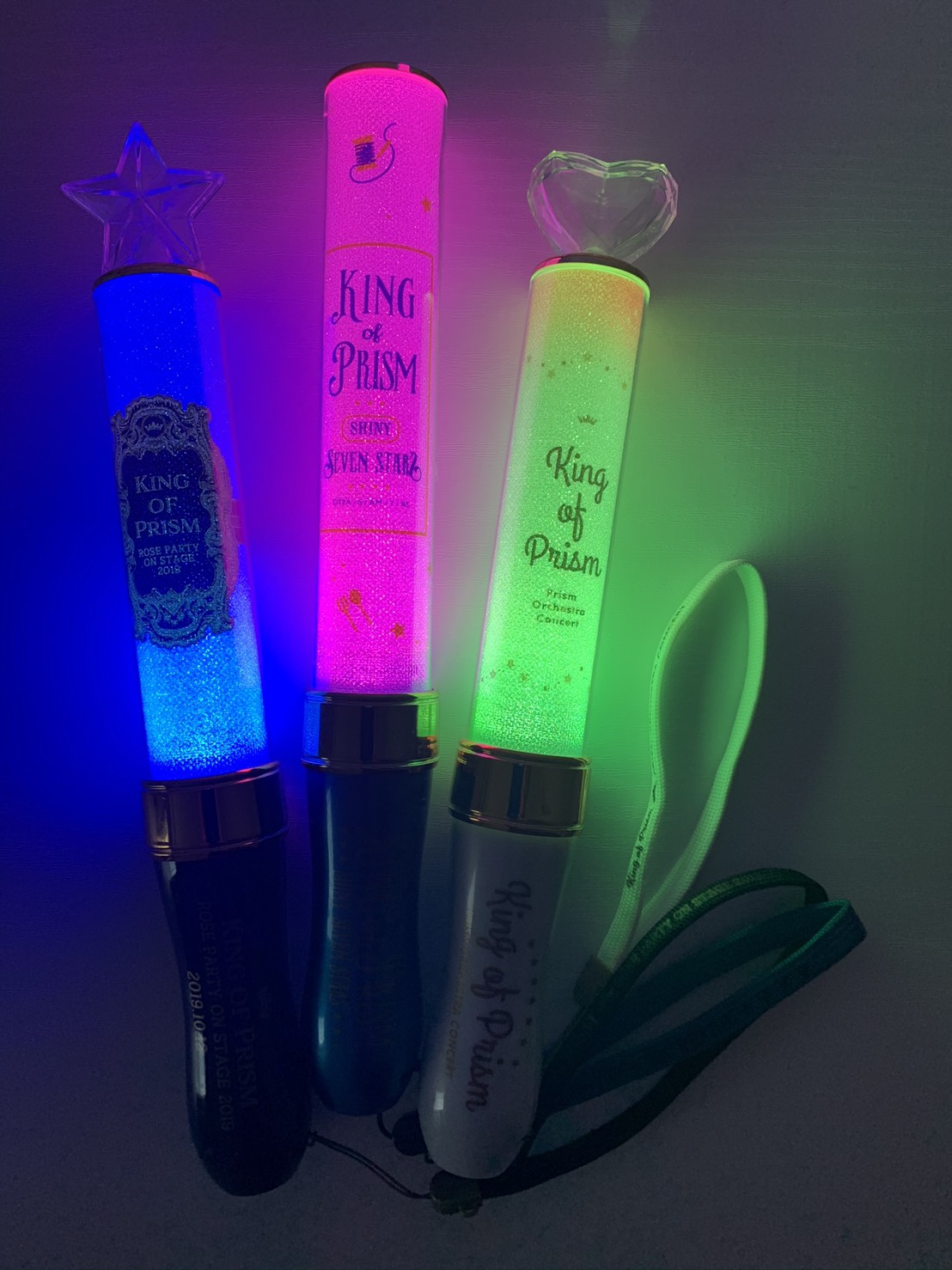 Three glowsticks, one blue, one pink, and one green, each with a King of Prism logo.