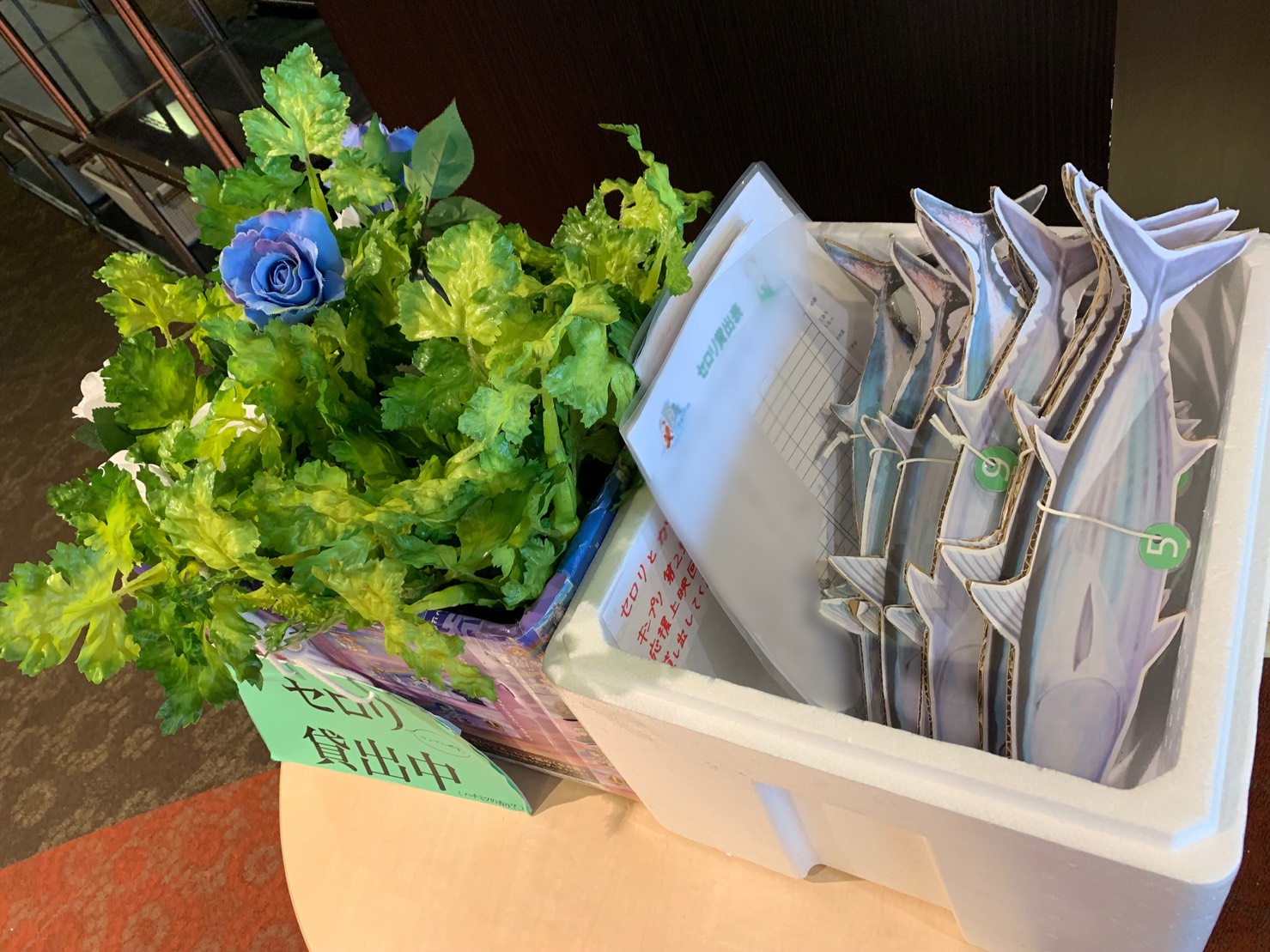 Materials available at the movie theater for audiences to rent to use when cheering. Those shown include popular items from the King of Prism series, like celery sticks and laminated pictures of bonito fish.