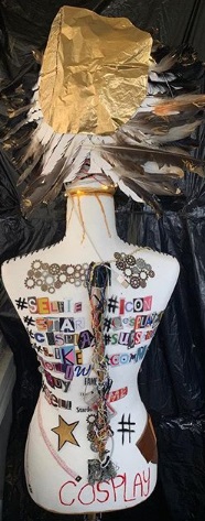 Bare mannequin's torso decorated with colorful words and symbols 