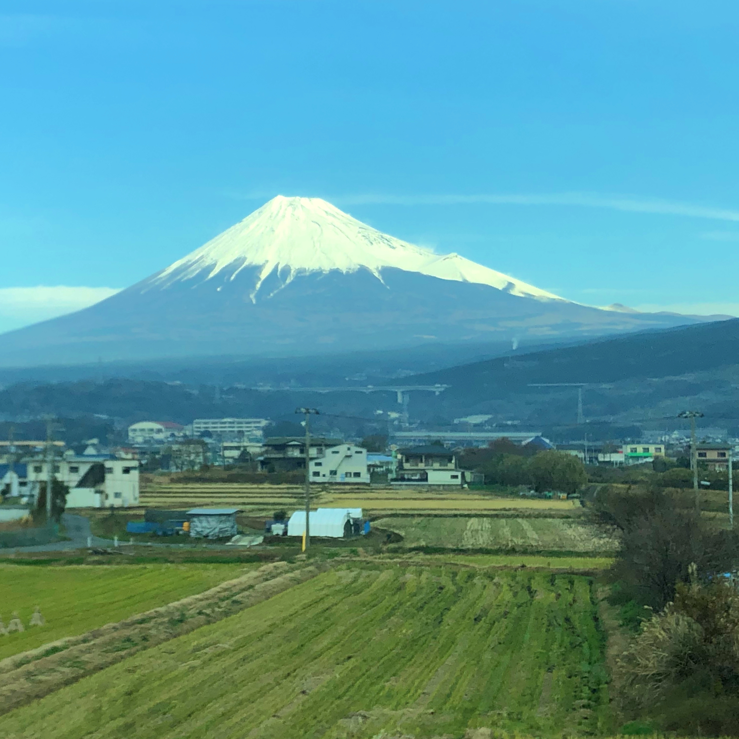 Mount Fuji with white, snow-covered top centered