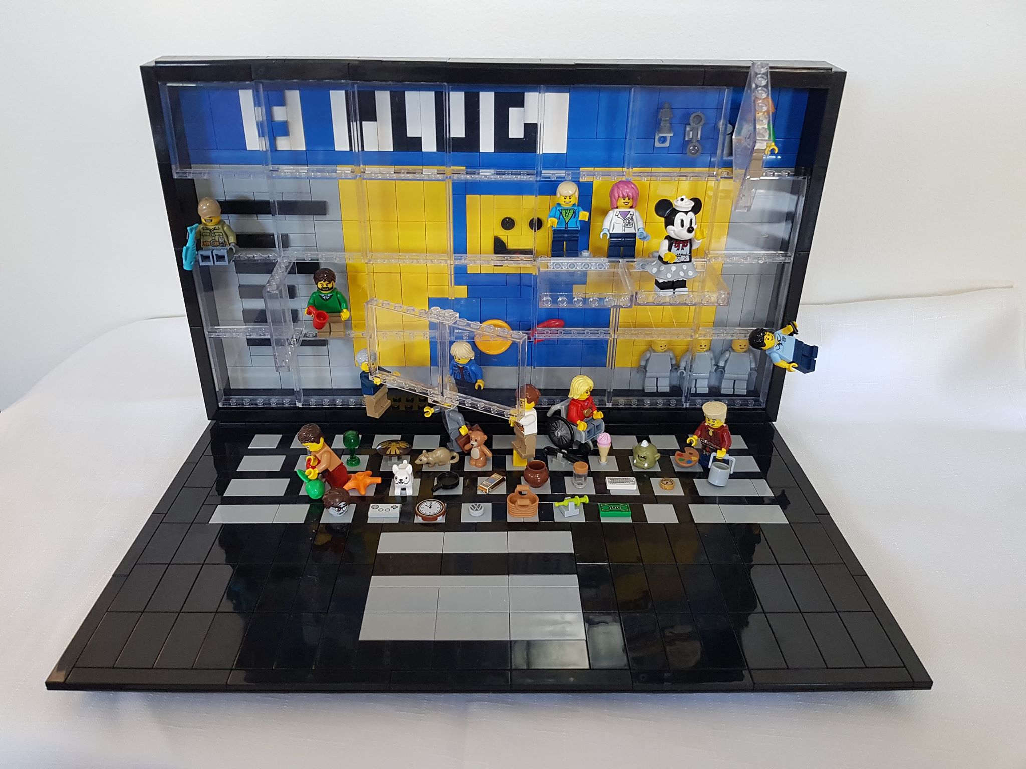 Image of a laptop made of Lego with minifigures emerging from computer screen.