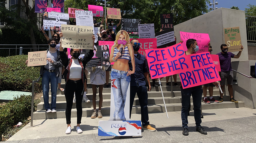Spears cutout located front and center, with fans behind her holding up signs