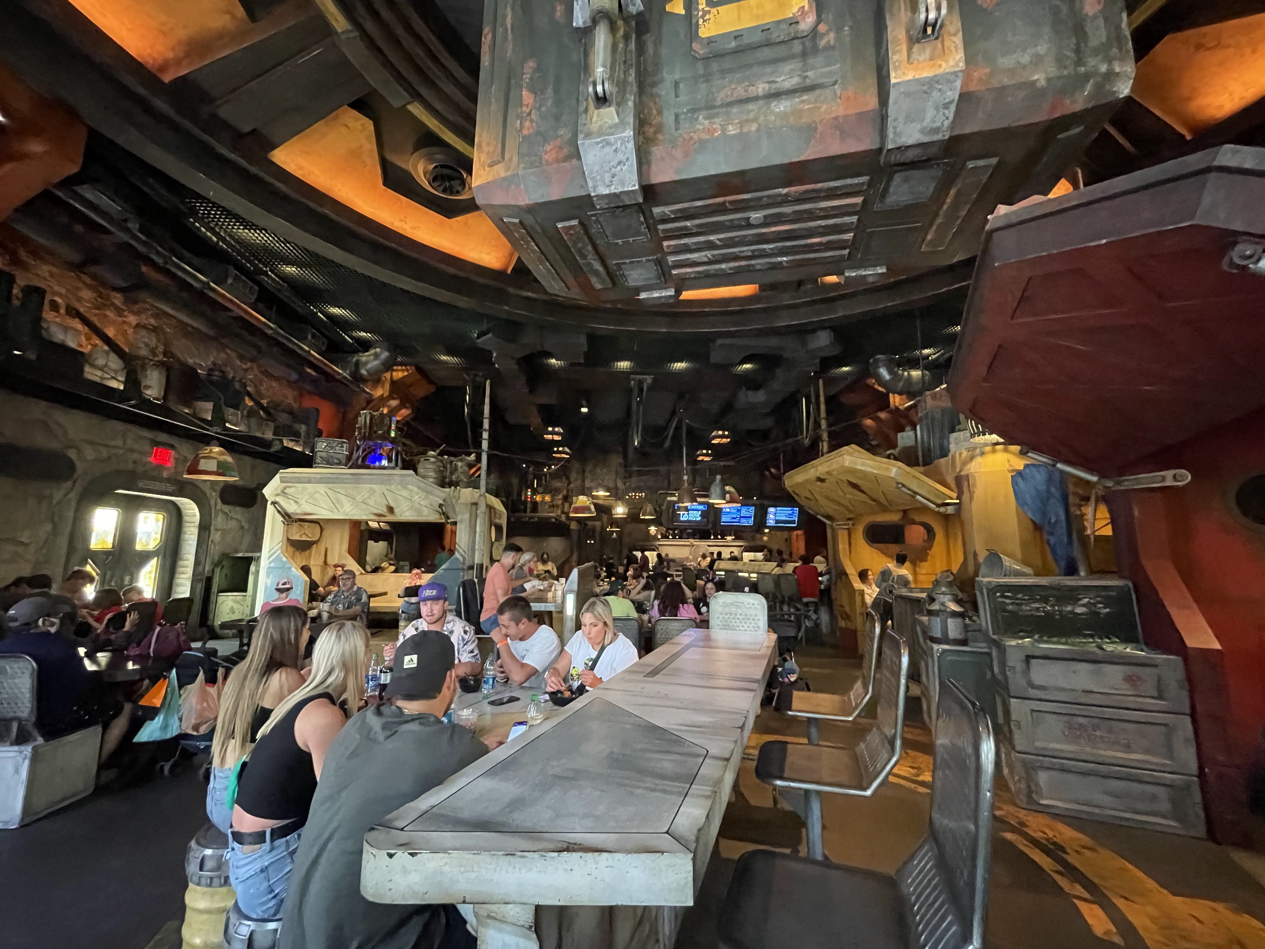 People eating in a food area designed to look like a hangar bay.
