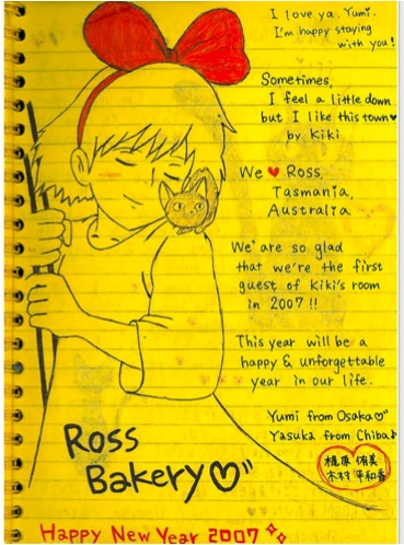 Page from the Ross Bakery guest book including a sketch of Kiki and the following greeting: I lova ya, Yumi. I'm happy staying with you! Sometimes I feel a little down but I like this town ♥ by Kiki. We ♥ Ross, Tasmania, Australia. We are so glad that we're the first guests of Kiki's room in 2007!! This year will be a happy & unforgettable year in our life. Yumi from Osaka, Yasuka from Chiba. Ross Bakery ♥ Happy New Year 2007