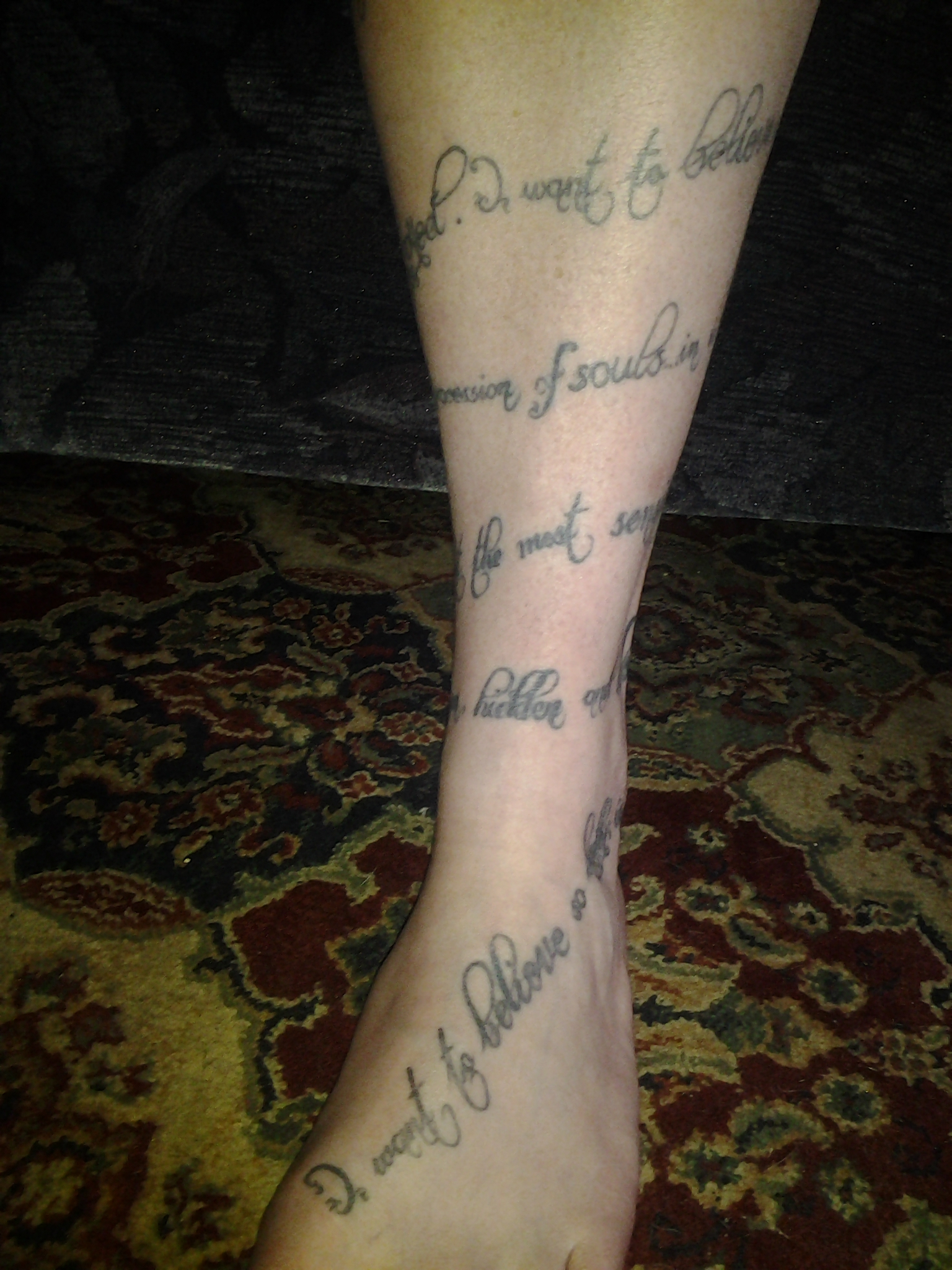 close up of tattoo in scripts 4 and 5, unreadable in photograph.